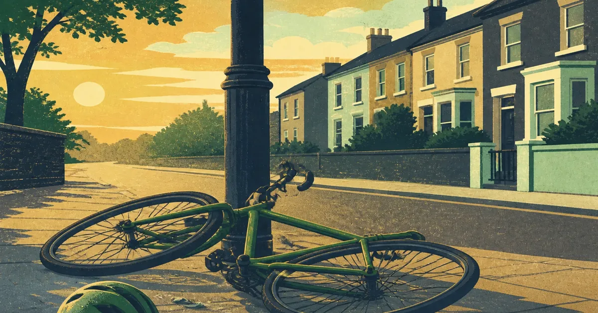 Cyclist checking a bicycle wheel after a fall on a quiet UK street